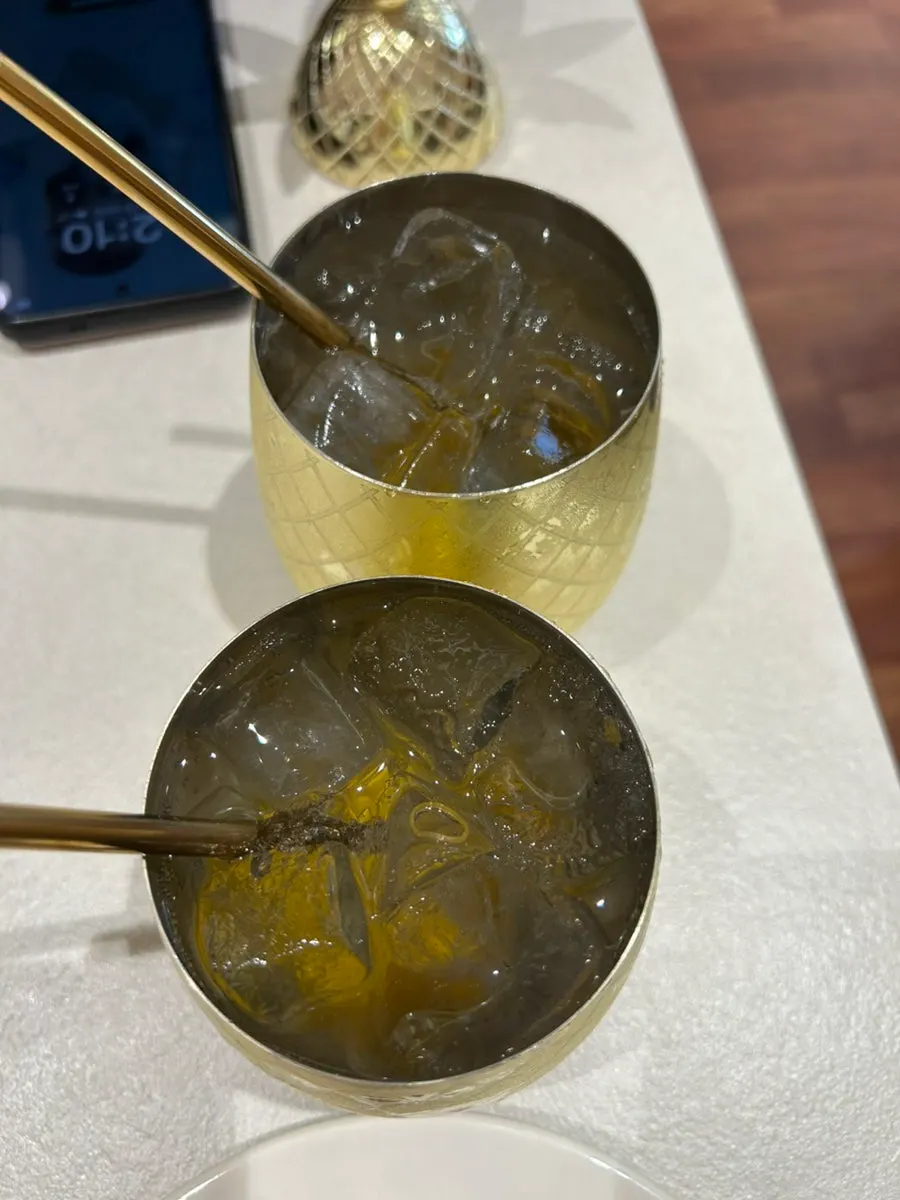 Two pineapple ades with leaf-shaped lids