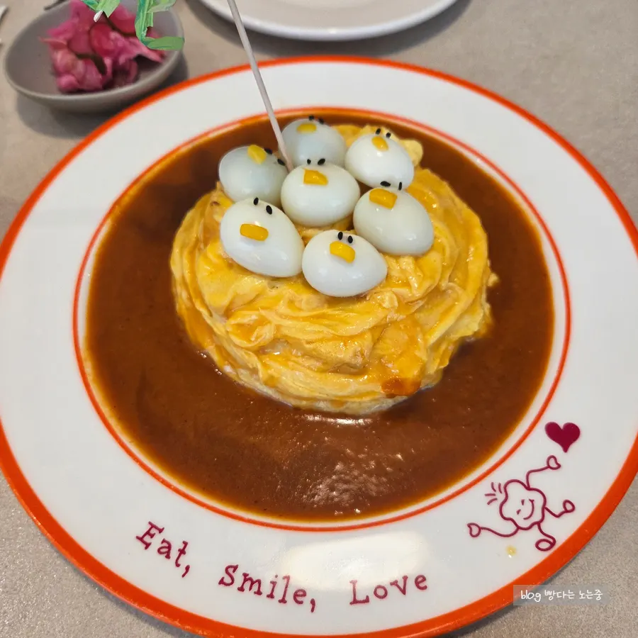 Rubber duck omurice dug into with a spoon
