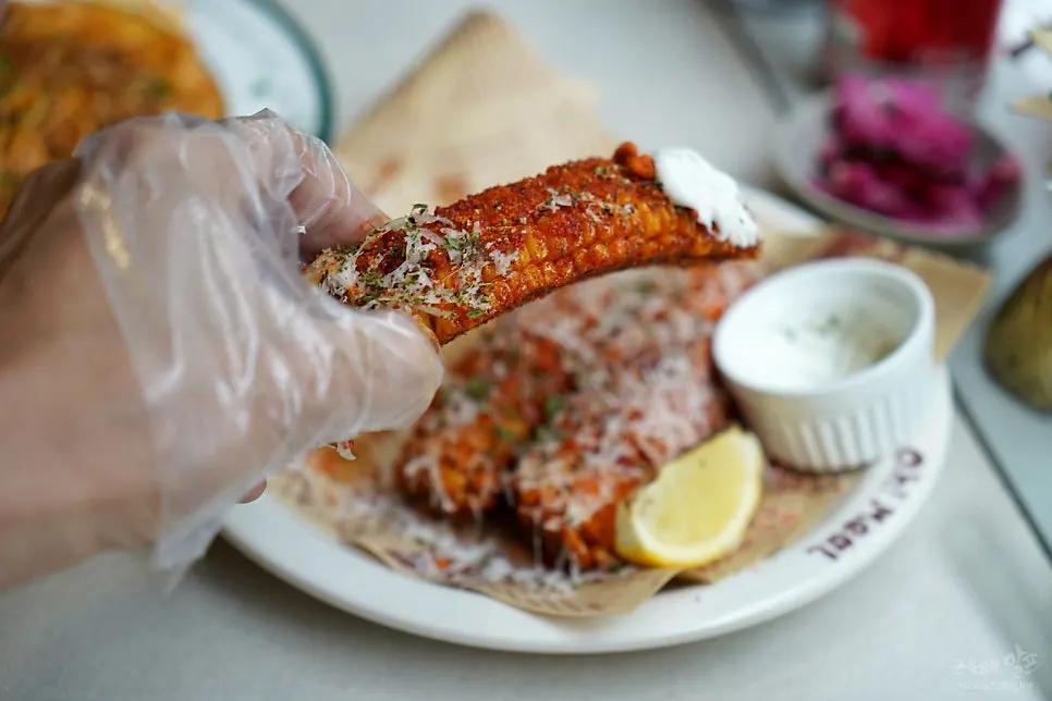 A bitten piece of whole corn fritter