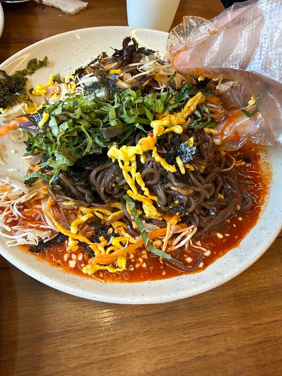 Eating jaengban makguksu alongside the meal