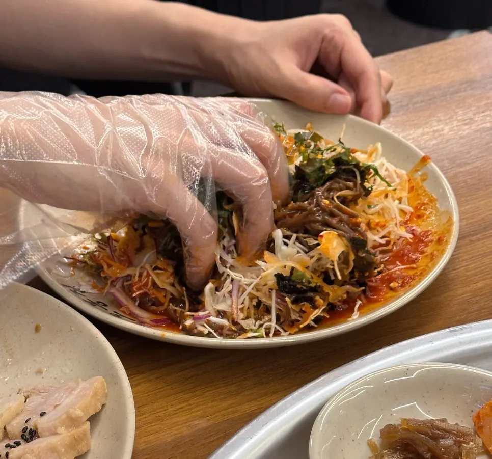 Full spread of stir-fried octopus, bossam, and makguksu noodles