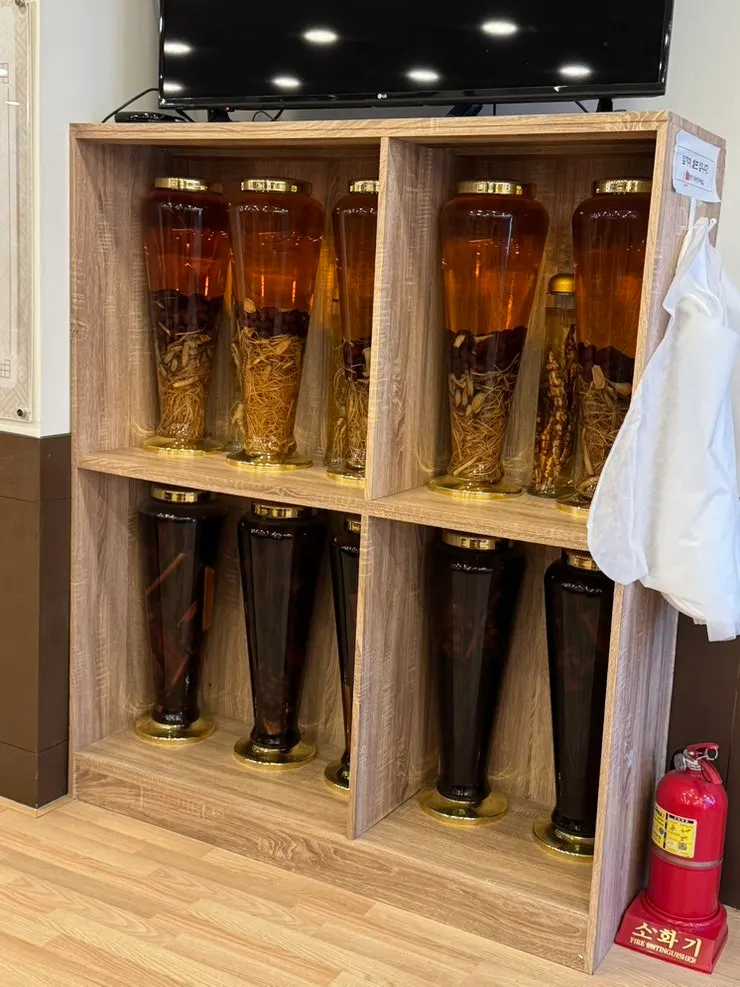Restaurant history sign showing operation since 1997, with infused liquor bottles displayed
