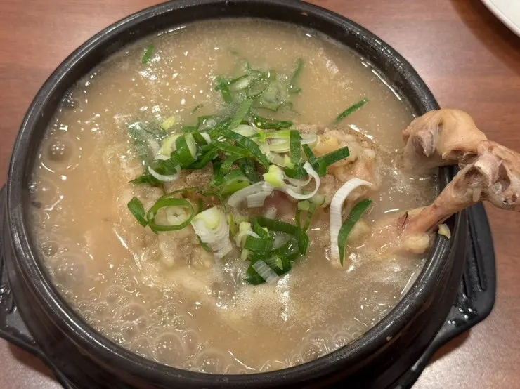 Herbal mung bean samgyetang served bubbling in a hot pot