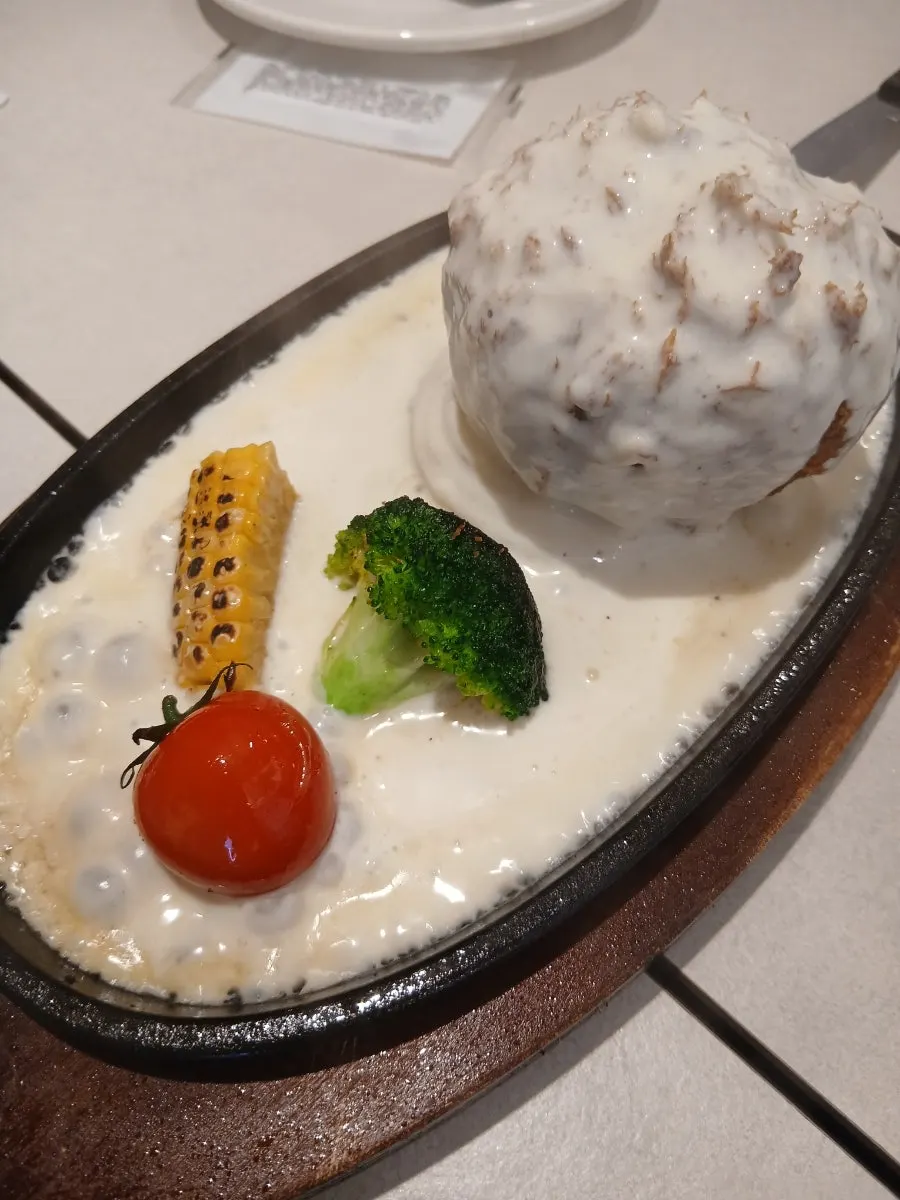 Sizzling cheese katsu served on a hot plate
