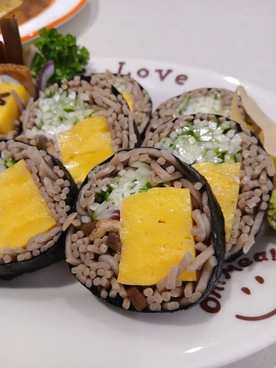 Egg roll soba maki with a cute face drawn on it
