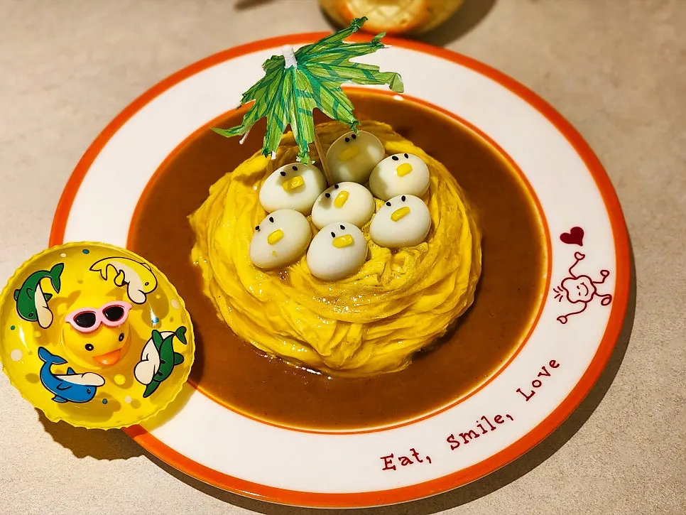 Rubber duck omurice served with a duck toy and tube float