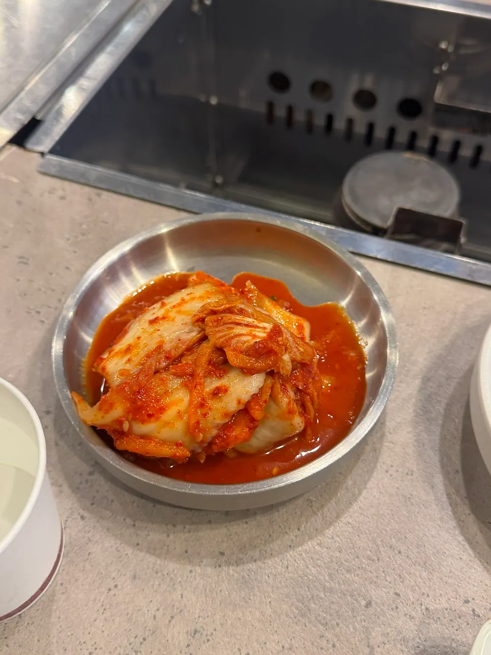 Table set with chojang sauce, soy-wasabi sauce, and kimchi side dishes