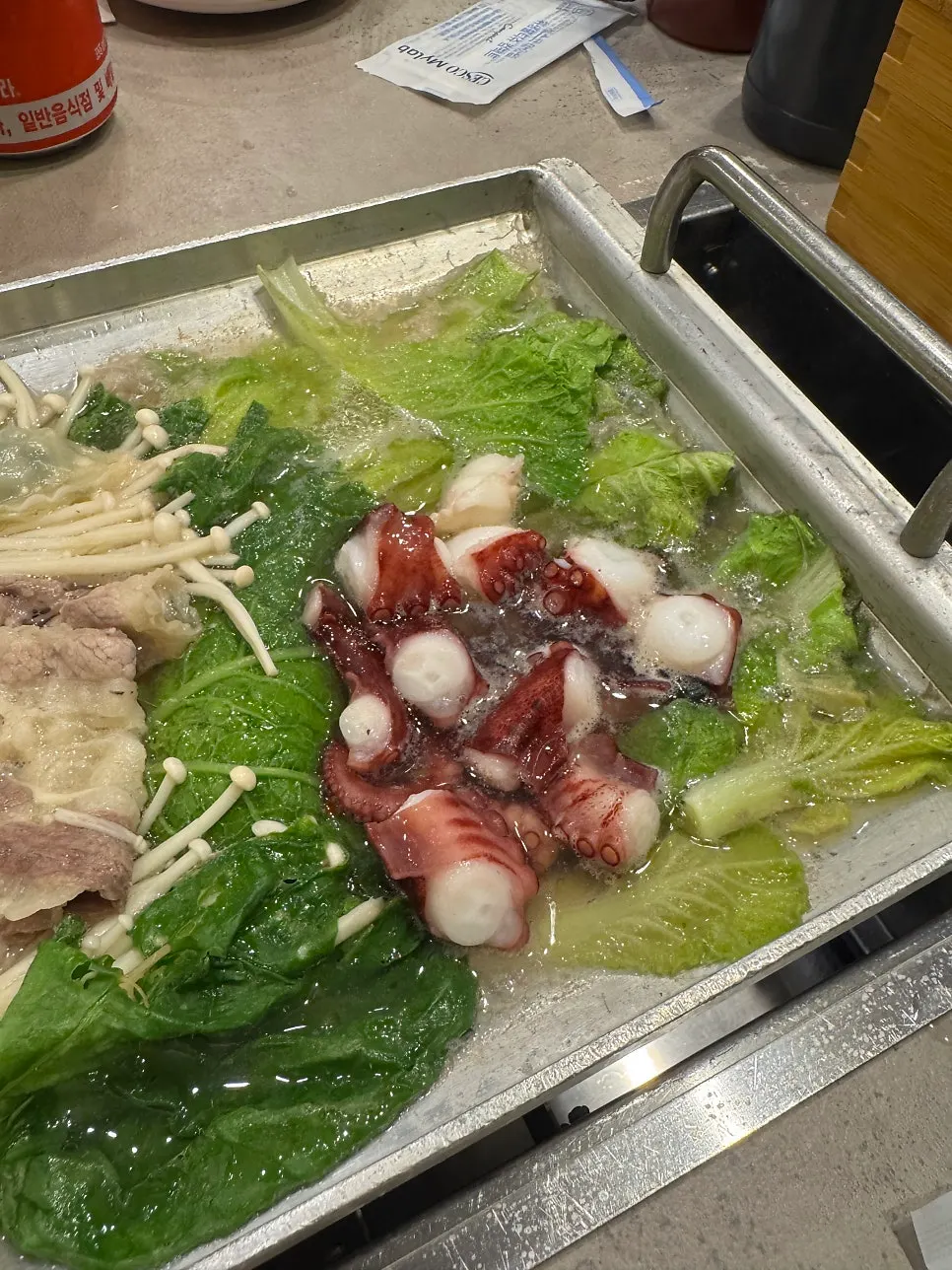 Octopus and beef brisket set aside separately on the right