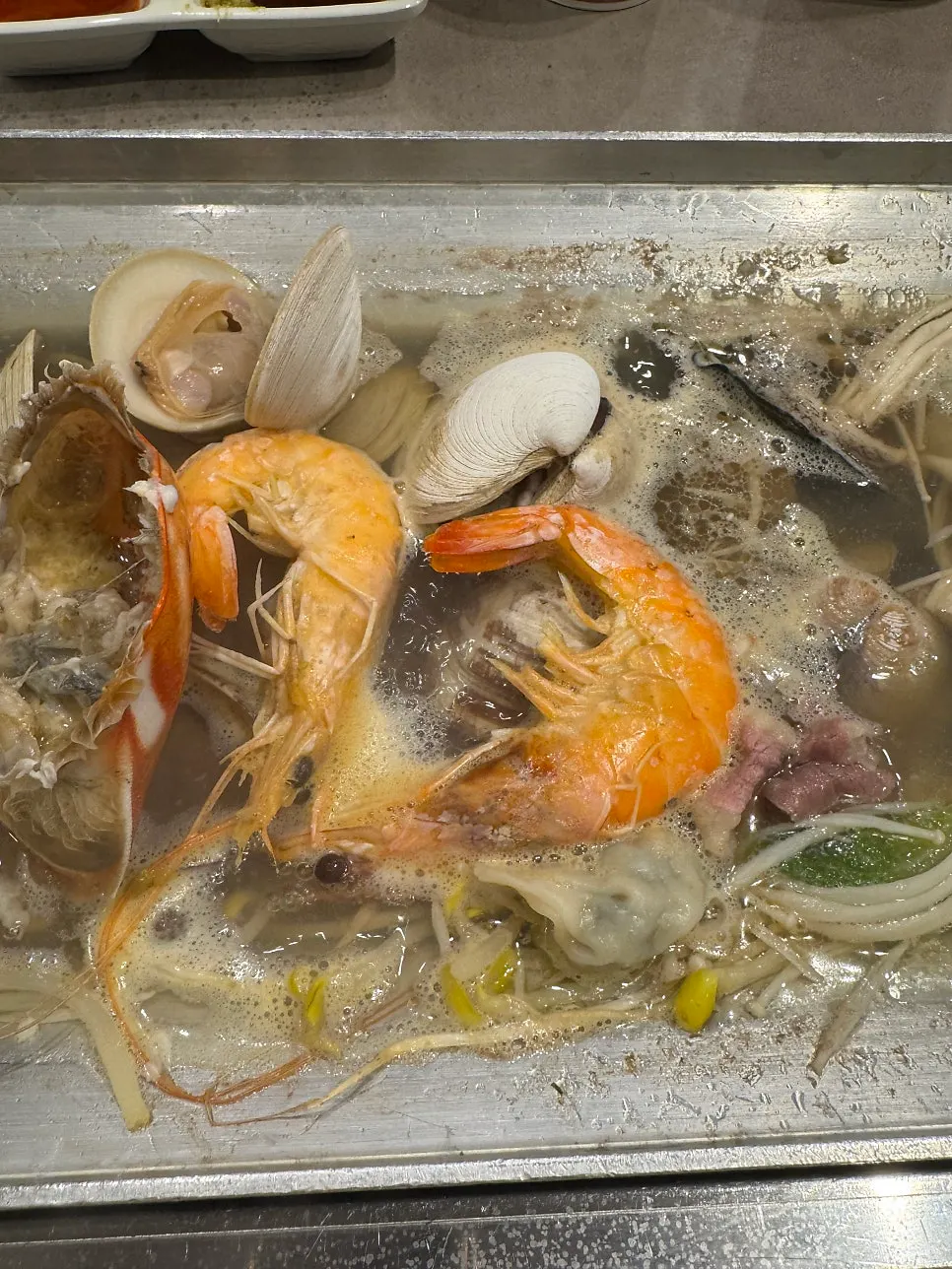 Large plump shellfish with shells opening as they cook