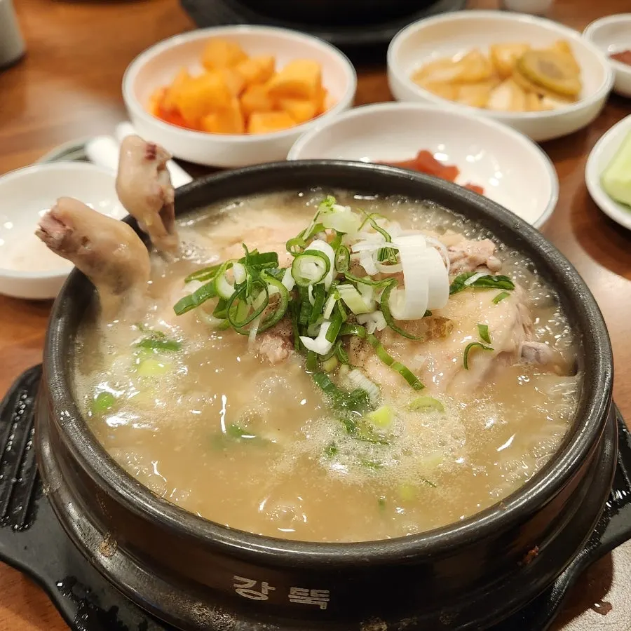 Picking chicken meat off the bone in the samgyetang
