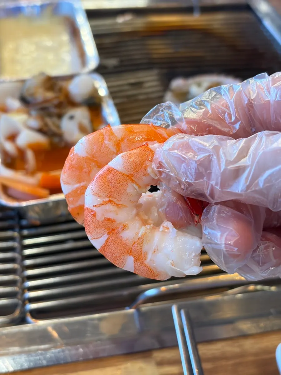 12 giant shrimp cooking on a bed of salt