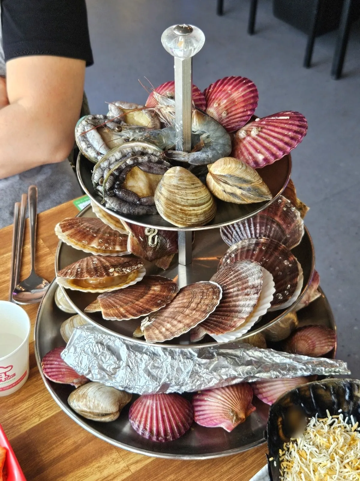 Large mixed grilled clam platter served on a three-tier tray