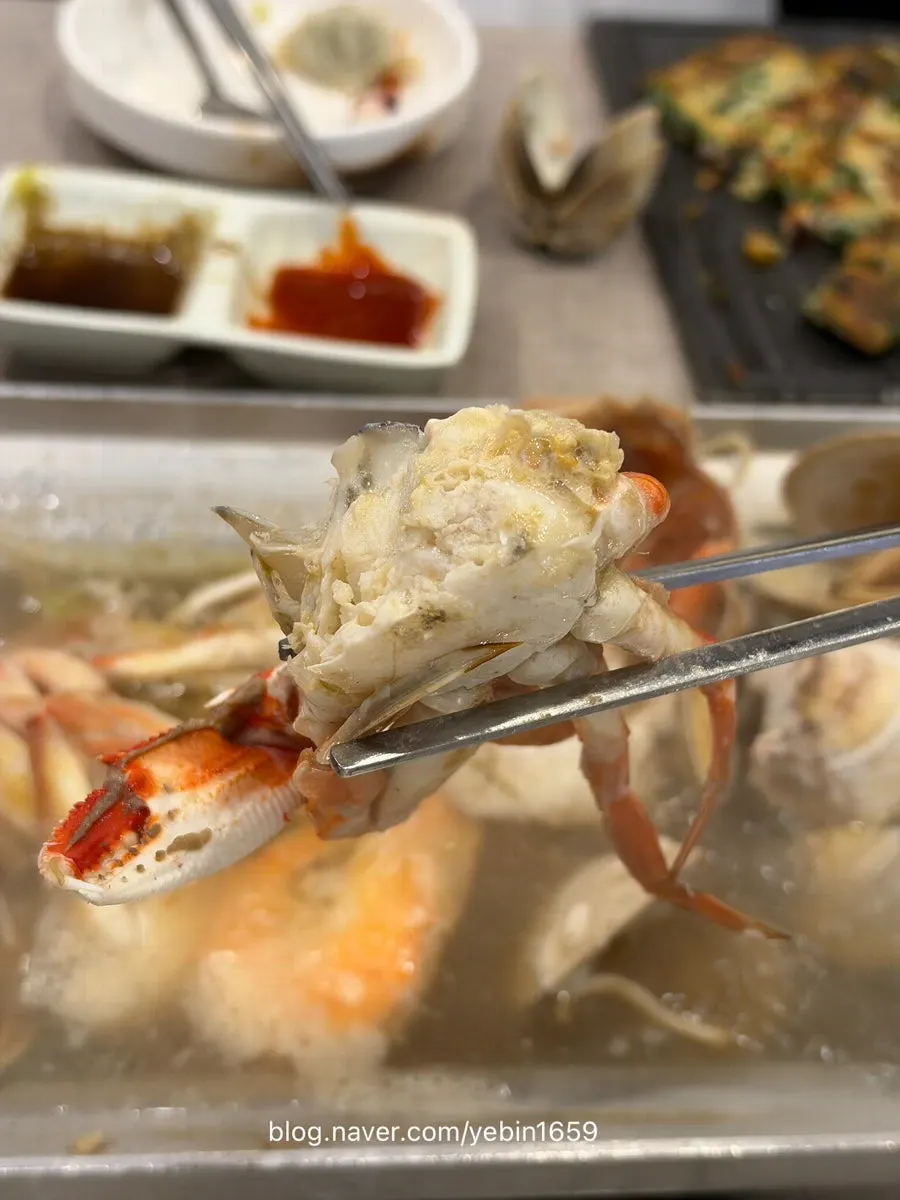 A small plate of seafood scooped out from the pan
