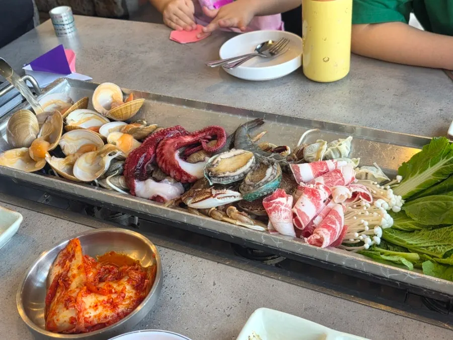 Seafood whole-pot kalguksu filled with seafood and vegetables