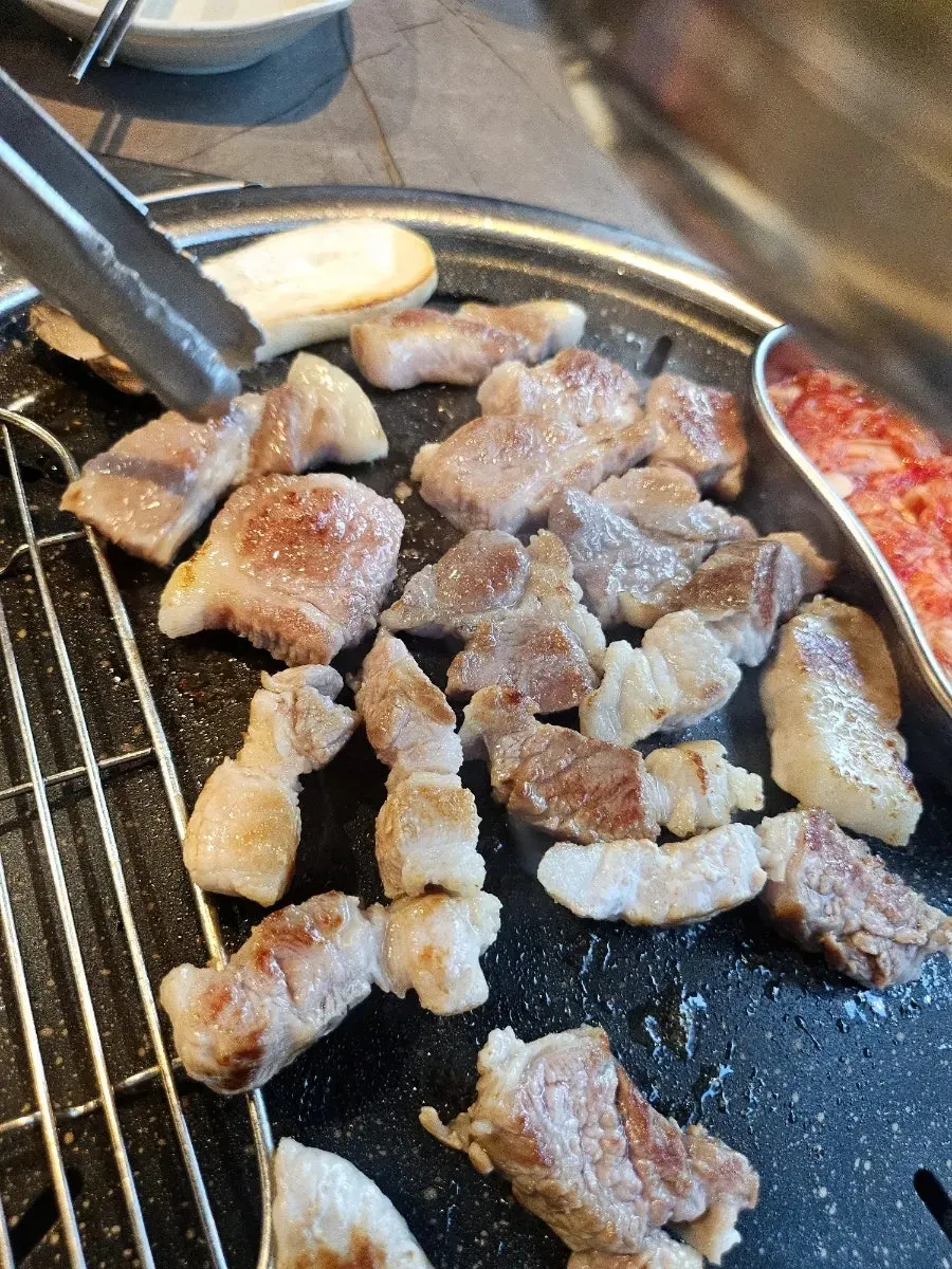 Meat turning golden brown on the grill