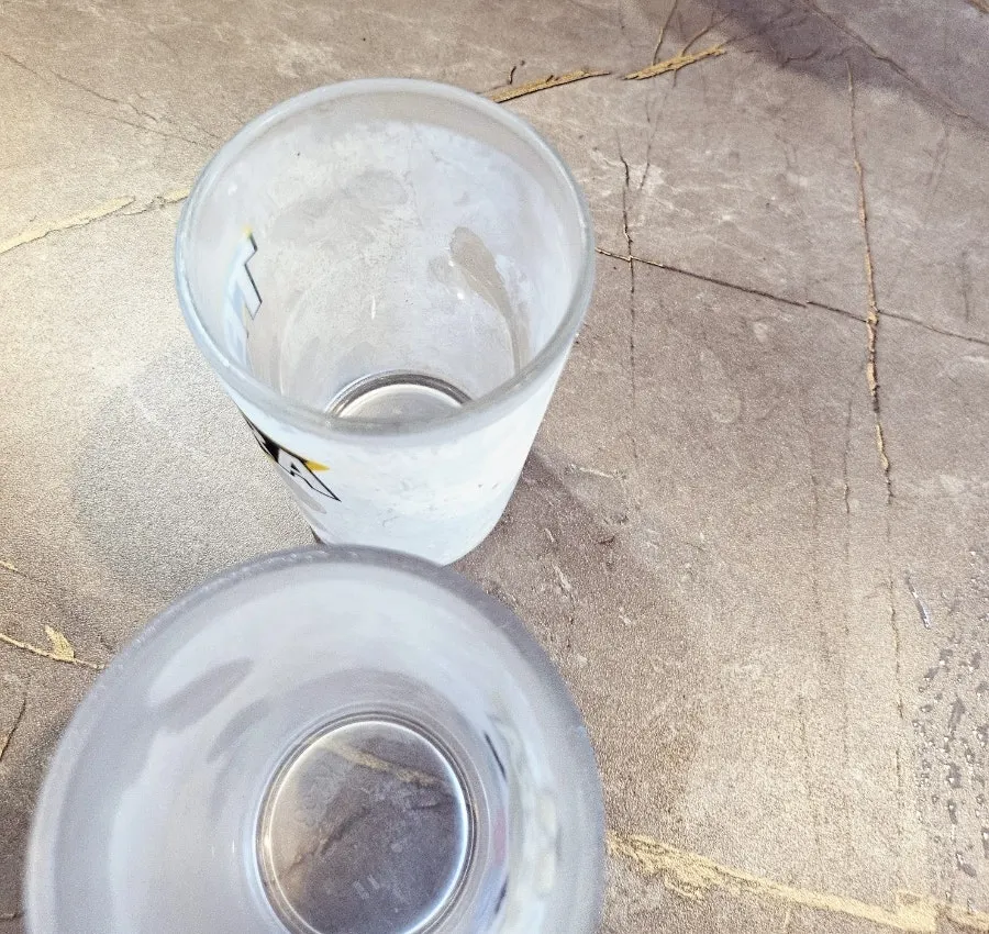 A glass of beer poured into a cold cup