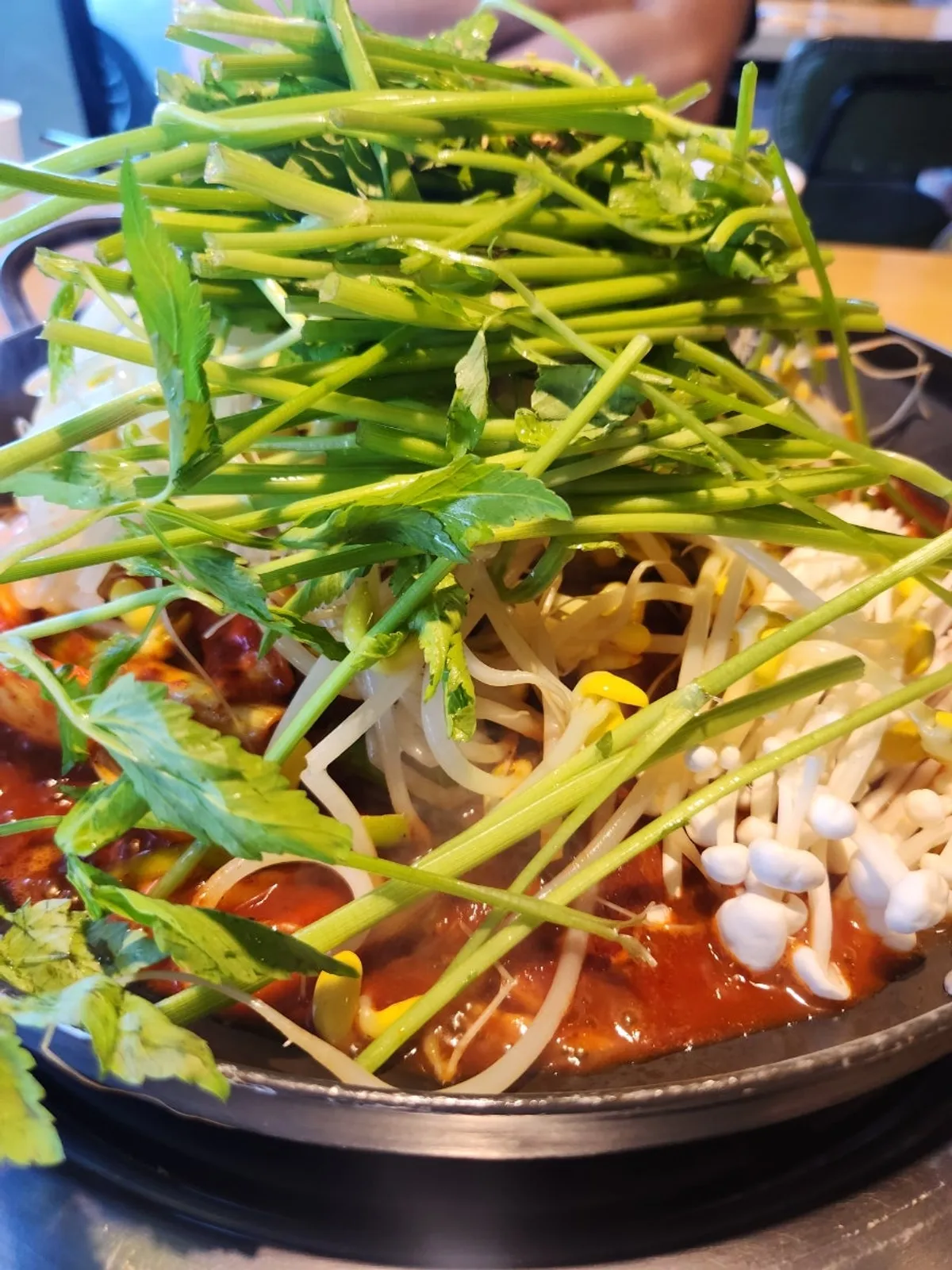 Squid duruchigi topped with bean sprouts and minari