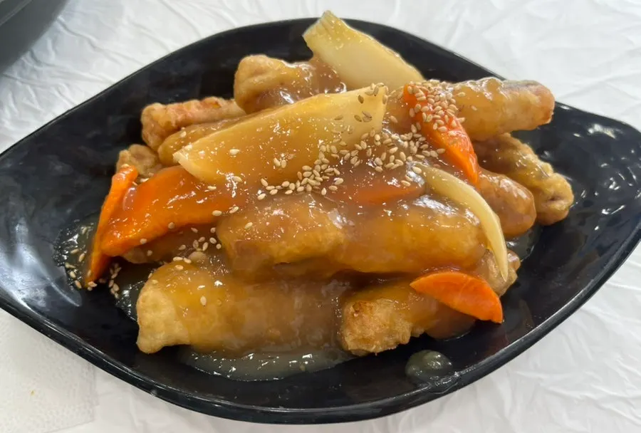 A bite of stir-fried squid on white rice