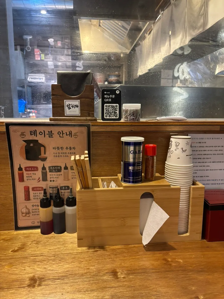 Table set with oolong tea, apron, and hair tie