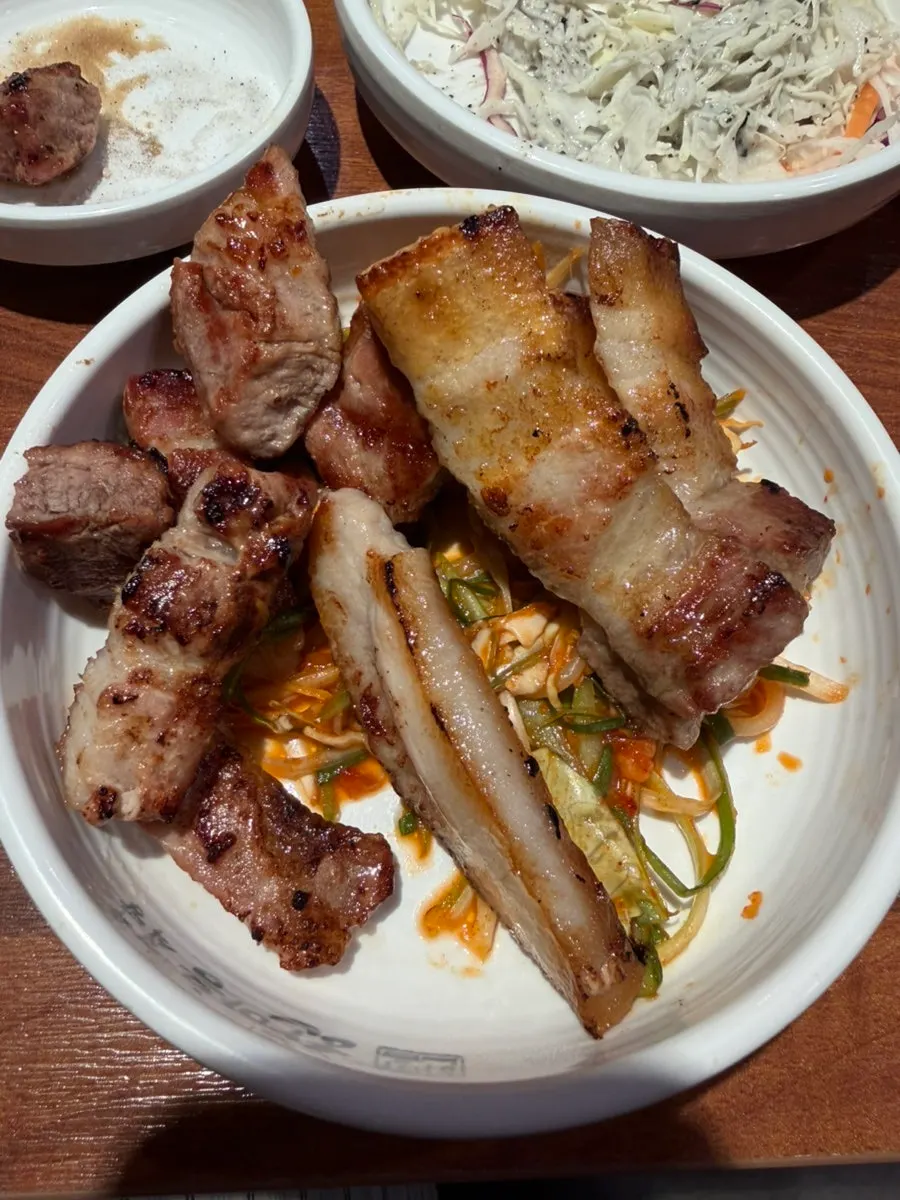 A bite of pork in a ssam wrap