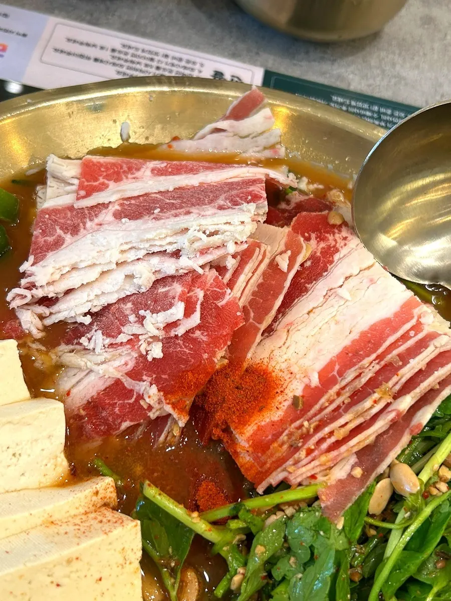 Close-up of the doenjang hot pot full of meat and tofu