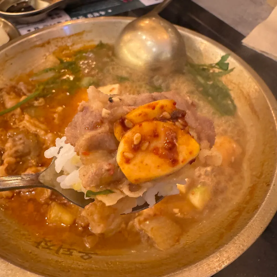 A spoonful of rice mixed into the doenjang broth