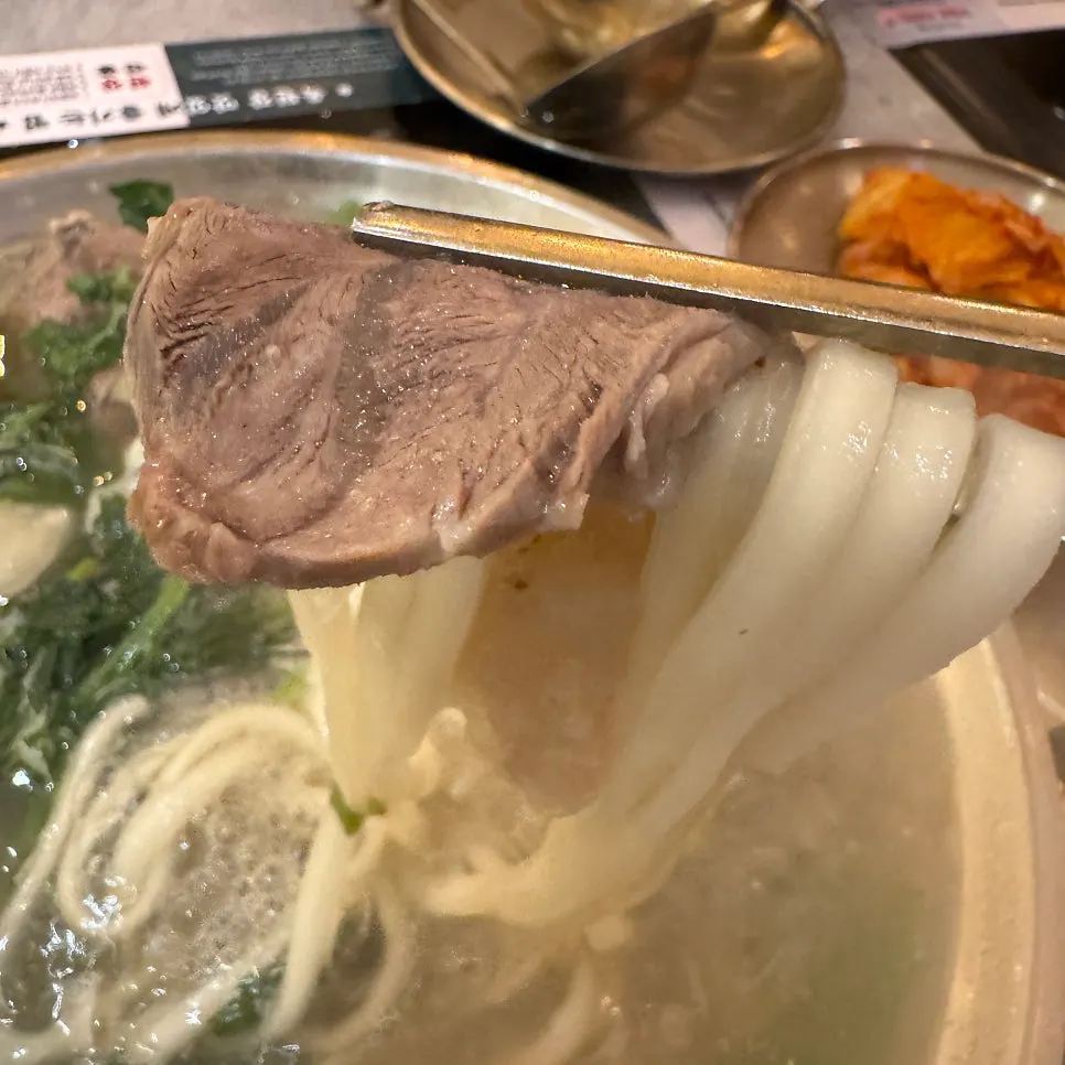 Clear boiled pork hot pot with the kalguksu noodles cooked through