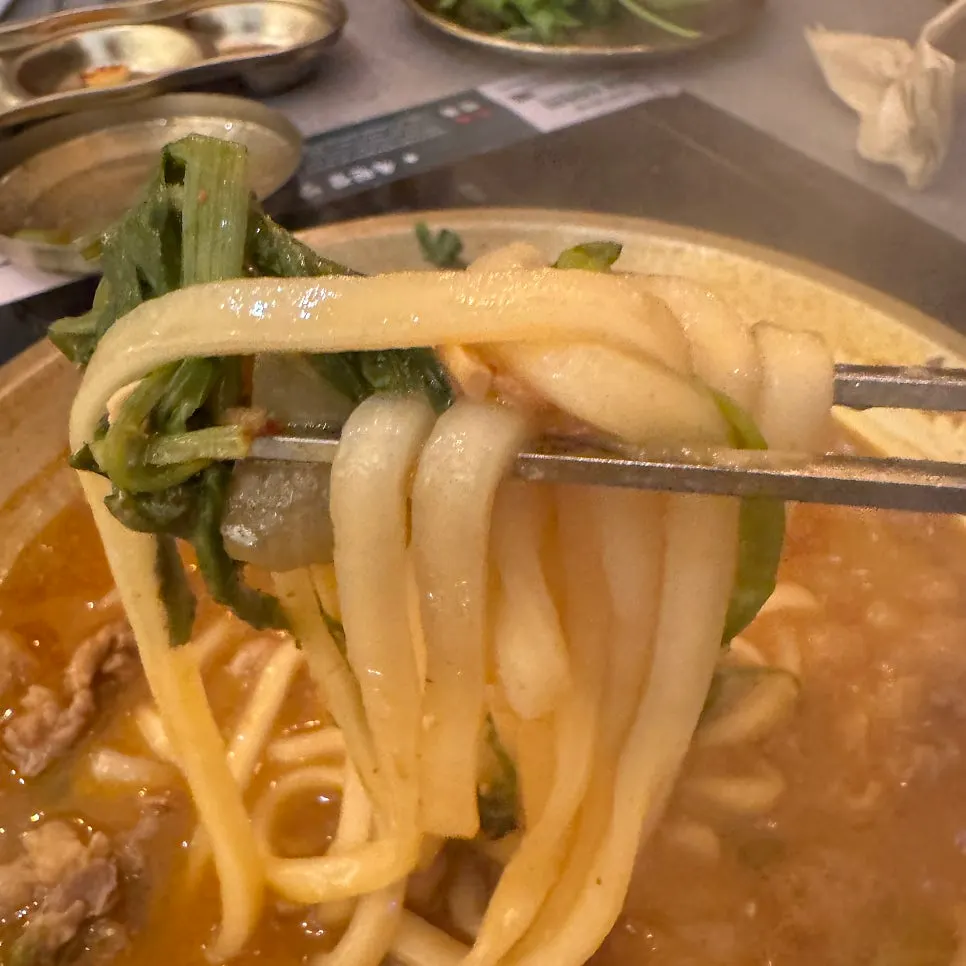 A spoonful of sujebi soaked in doenjang broth