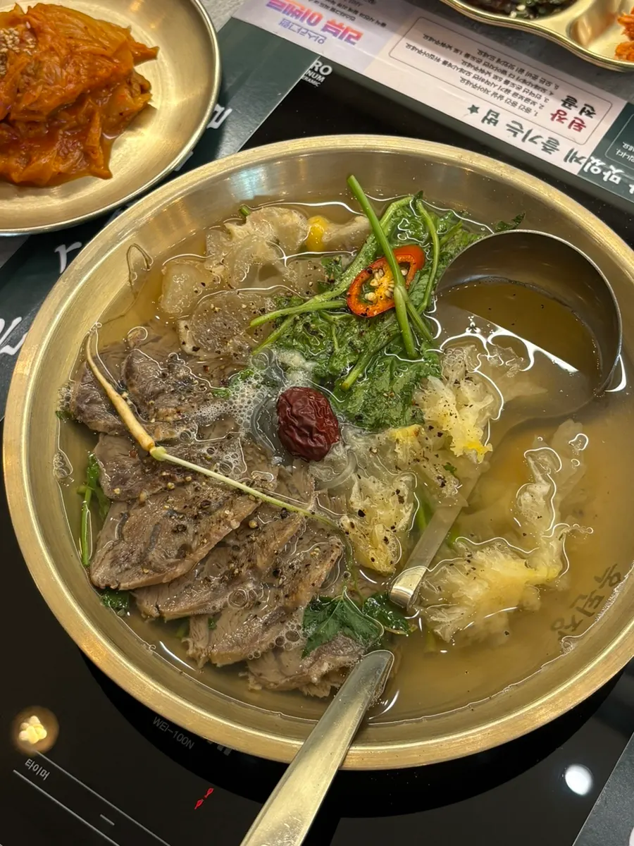 Meat and mushrooms lifted out of the hot pot