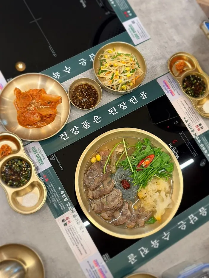 Table full with boiled pork hot pot, pancake, and pork salad