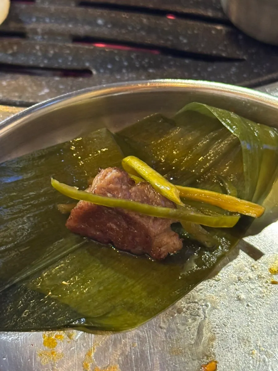A serving of grilled baek kimchi and pork
