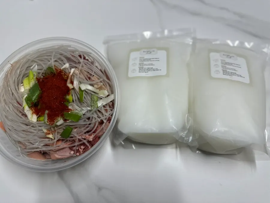 Budae-jjigae takeout with broth and ingredients packed separately