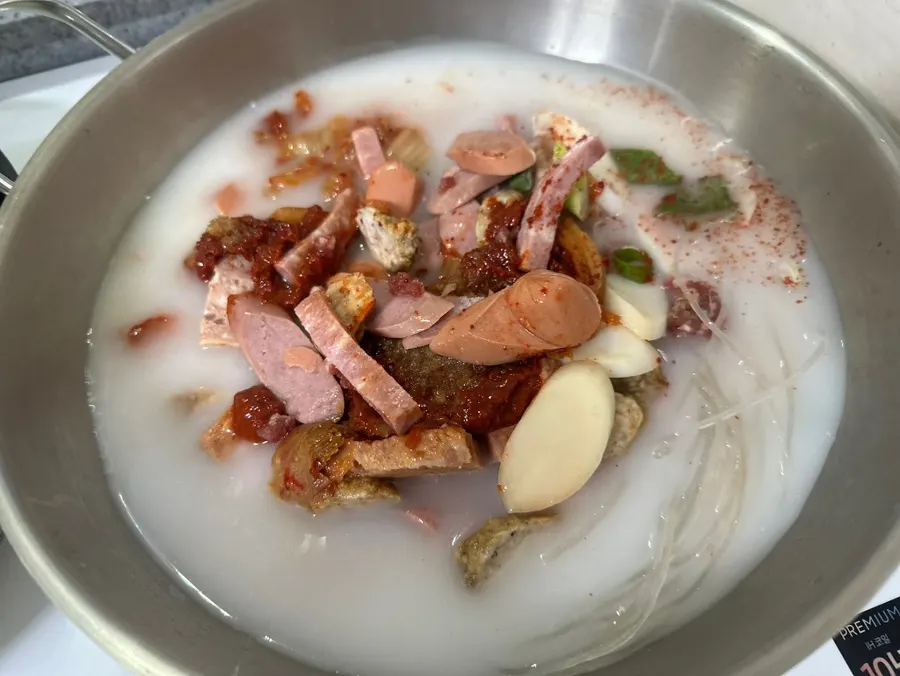 Milky-white broth poured into a pot