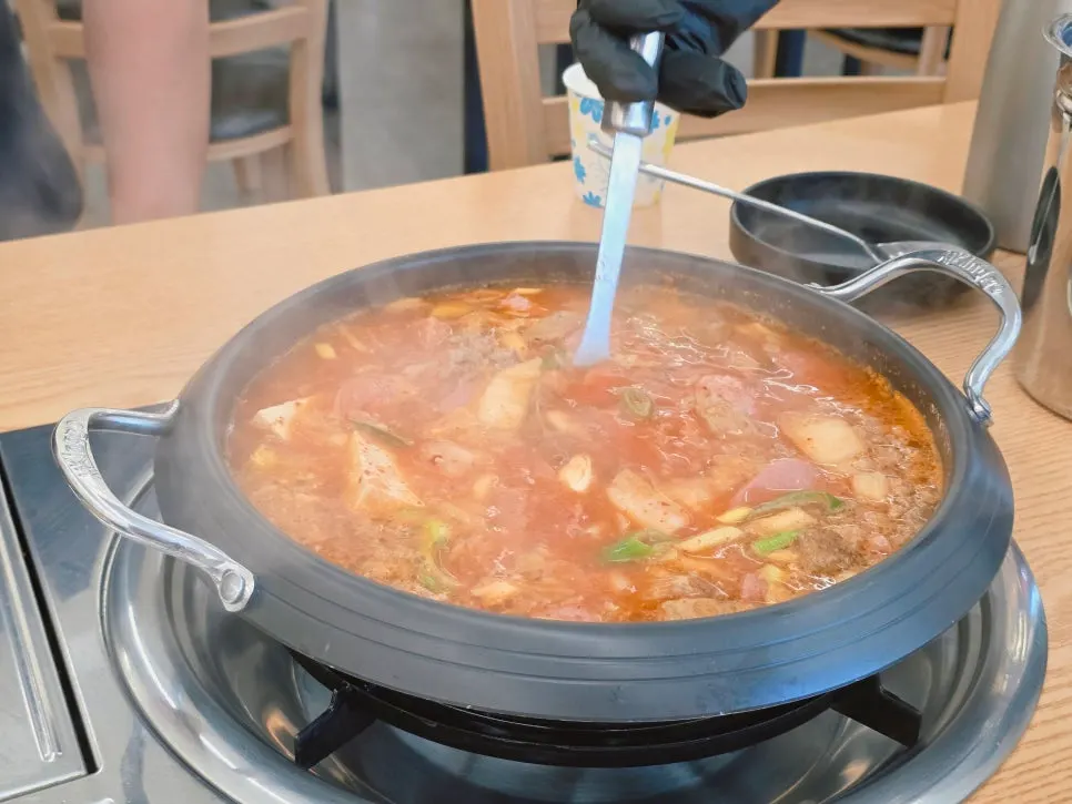 Budae-jjigae bubbling on the tabletop burner