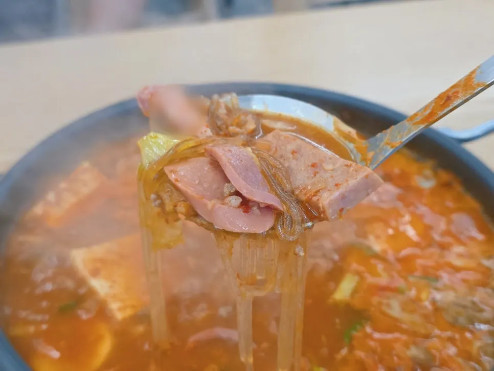 Pot of budae-jjigae with tofu and vegetables mixed in