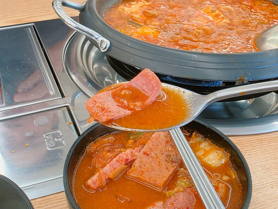 Spoonful of spicy budae-jjigae broth