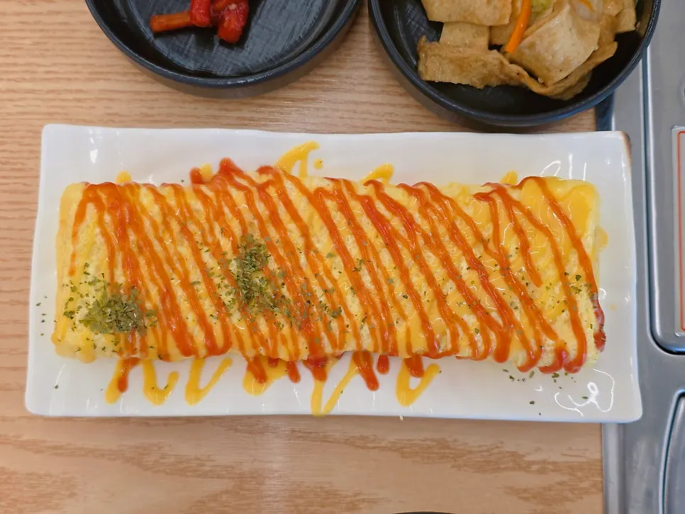 Egg roll drizzled with zigzag sauce