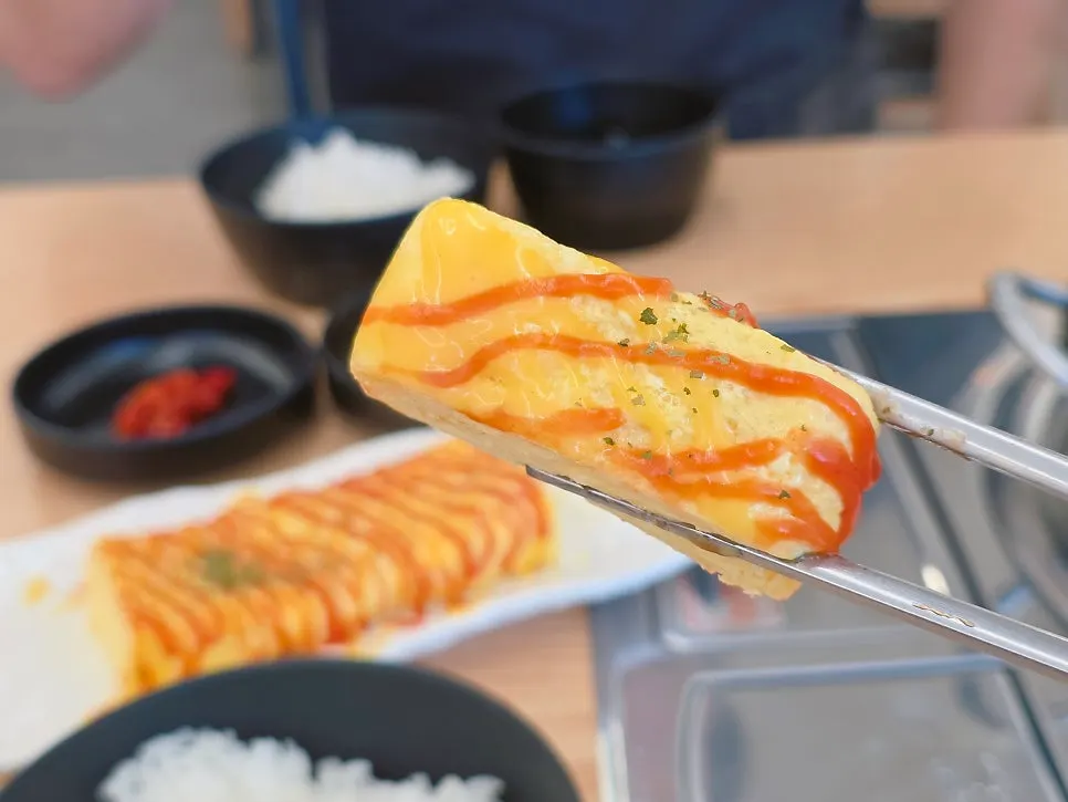 A cut piece of egg roll showing its thick cross-section