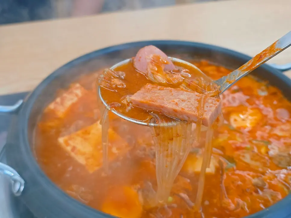Lunch table for two enjoying budae-jjigae