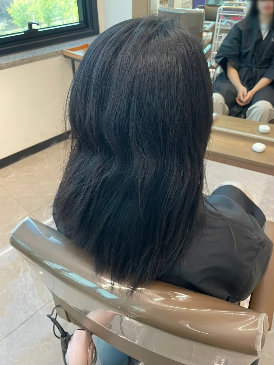 Back view of the finished layered cut and volume magic straightening