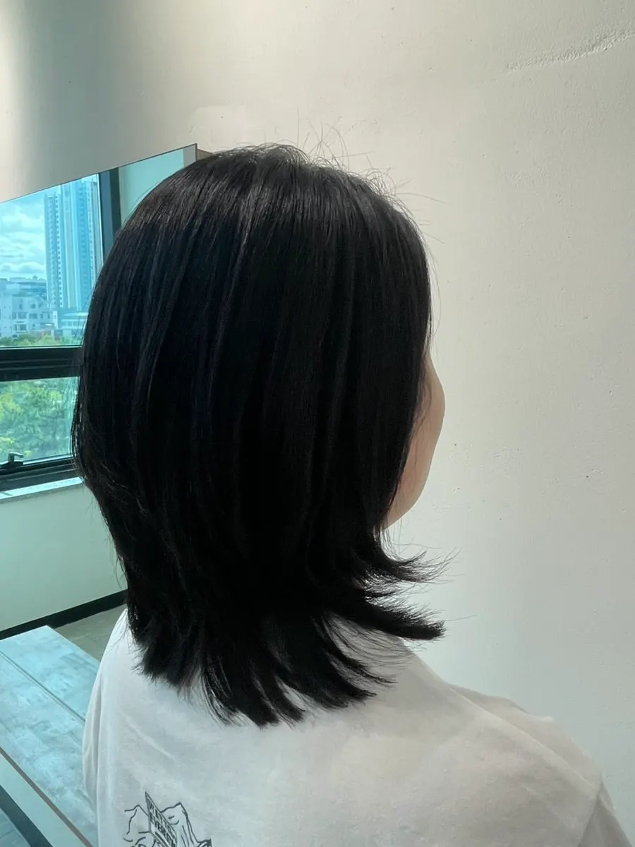 Front view of the finished layered cut and volume magic straightening