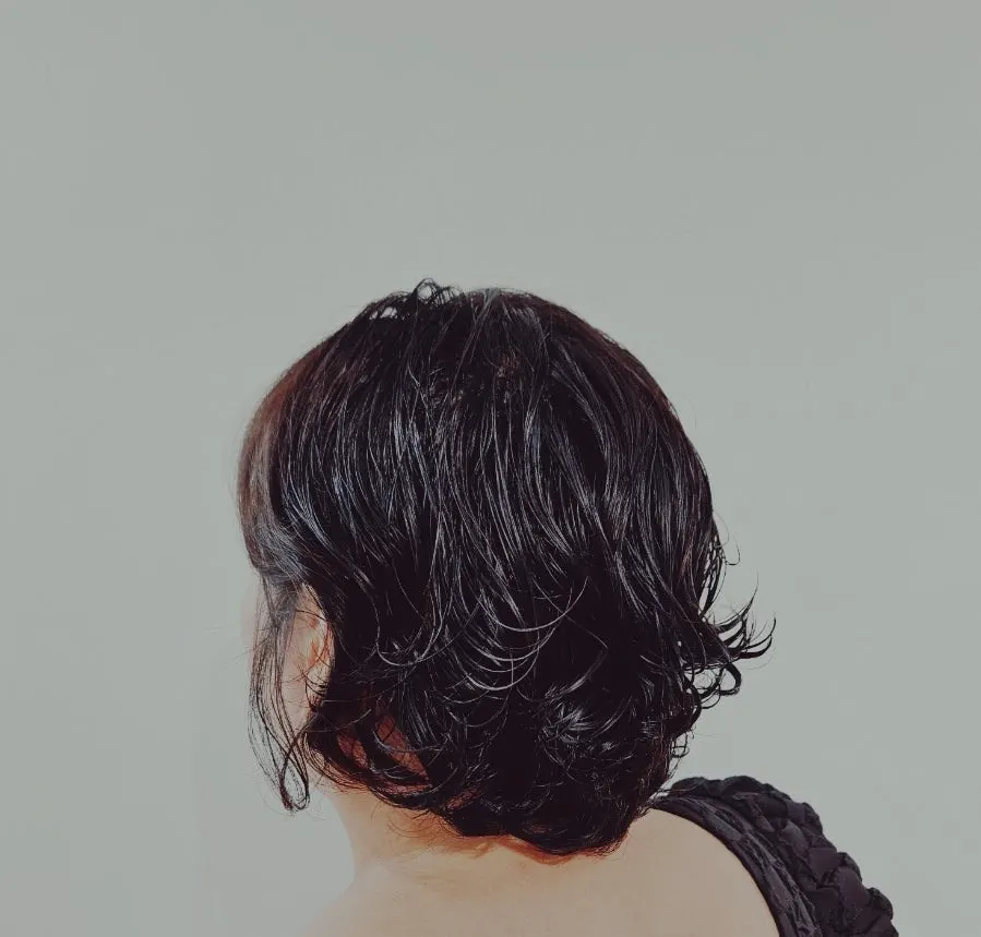 Back view of bob-length hippie perm with non-excessive volume