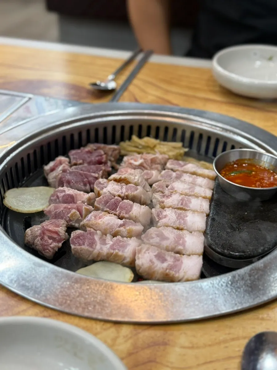 Staff cutting and grilling the meat