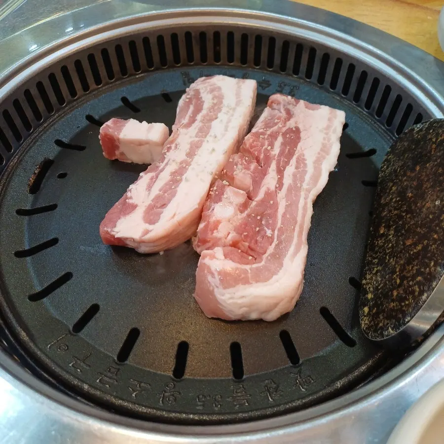 Thick aged fresh pork belly on the grill