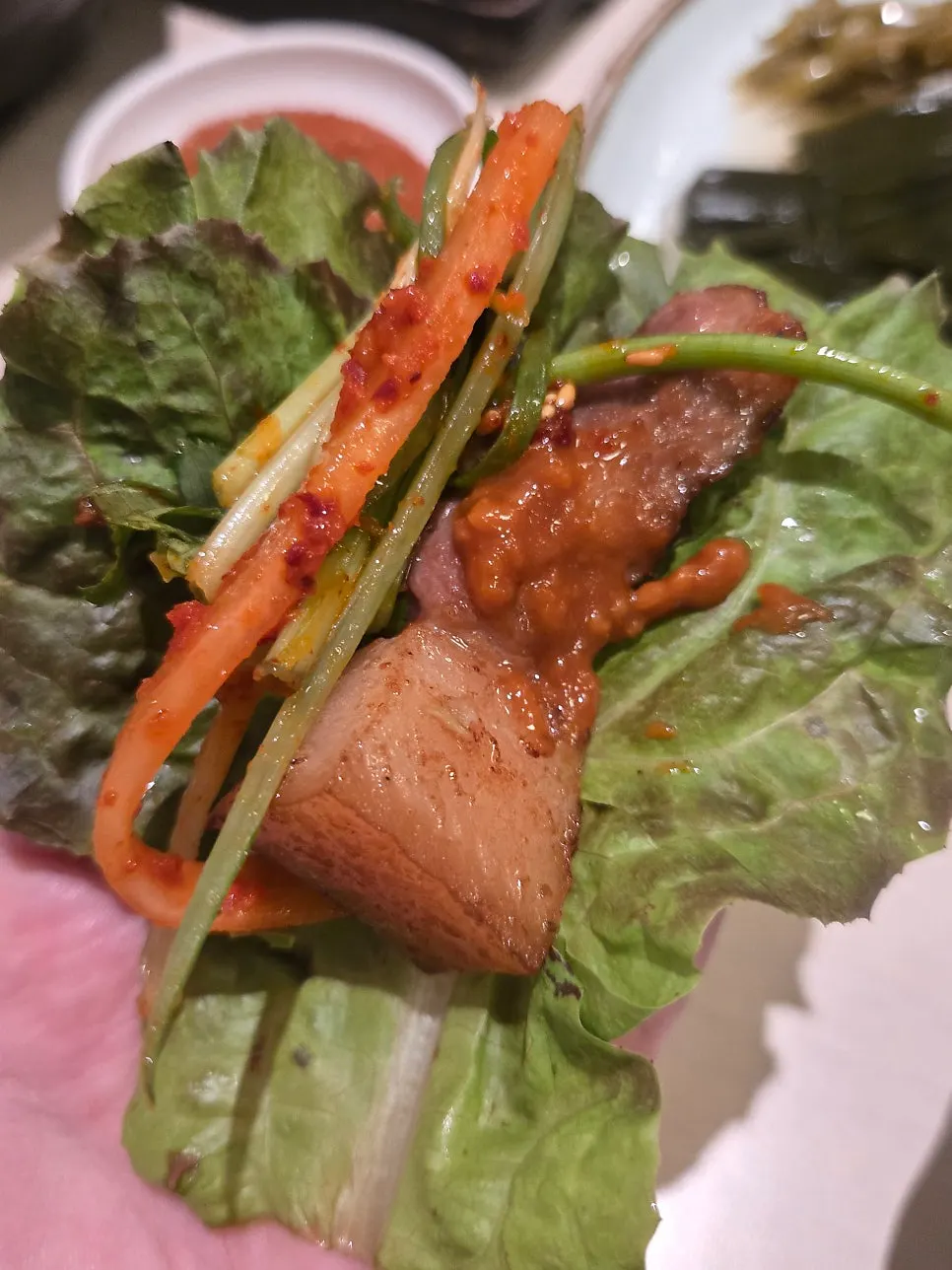 Lettuce wrap with meat, scallions, and radish salad