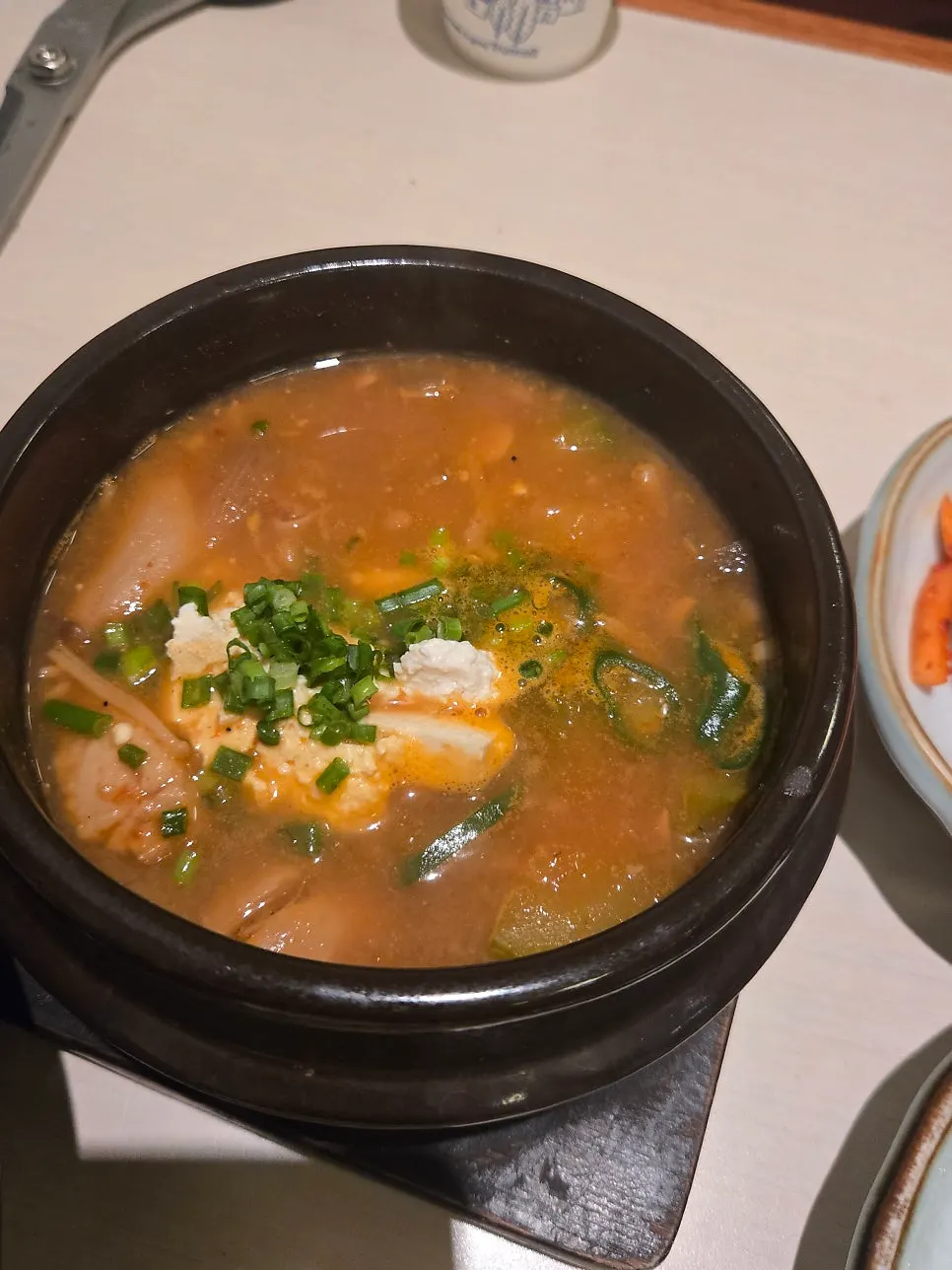 Homemade doenjang stew loaded with tofu and mushrooms