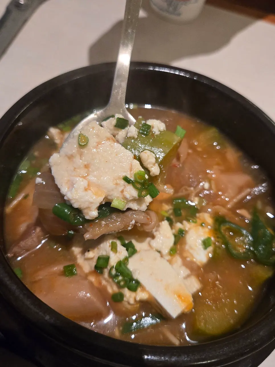 A spoonful of rice topped with meat