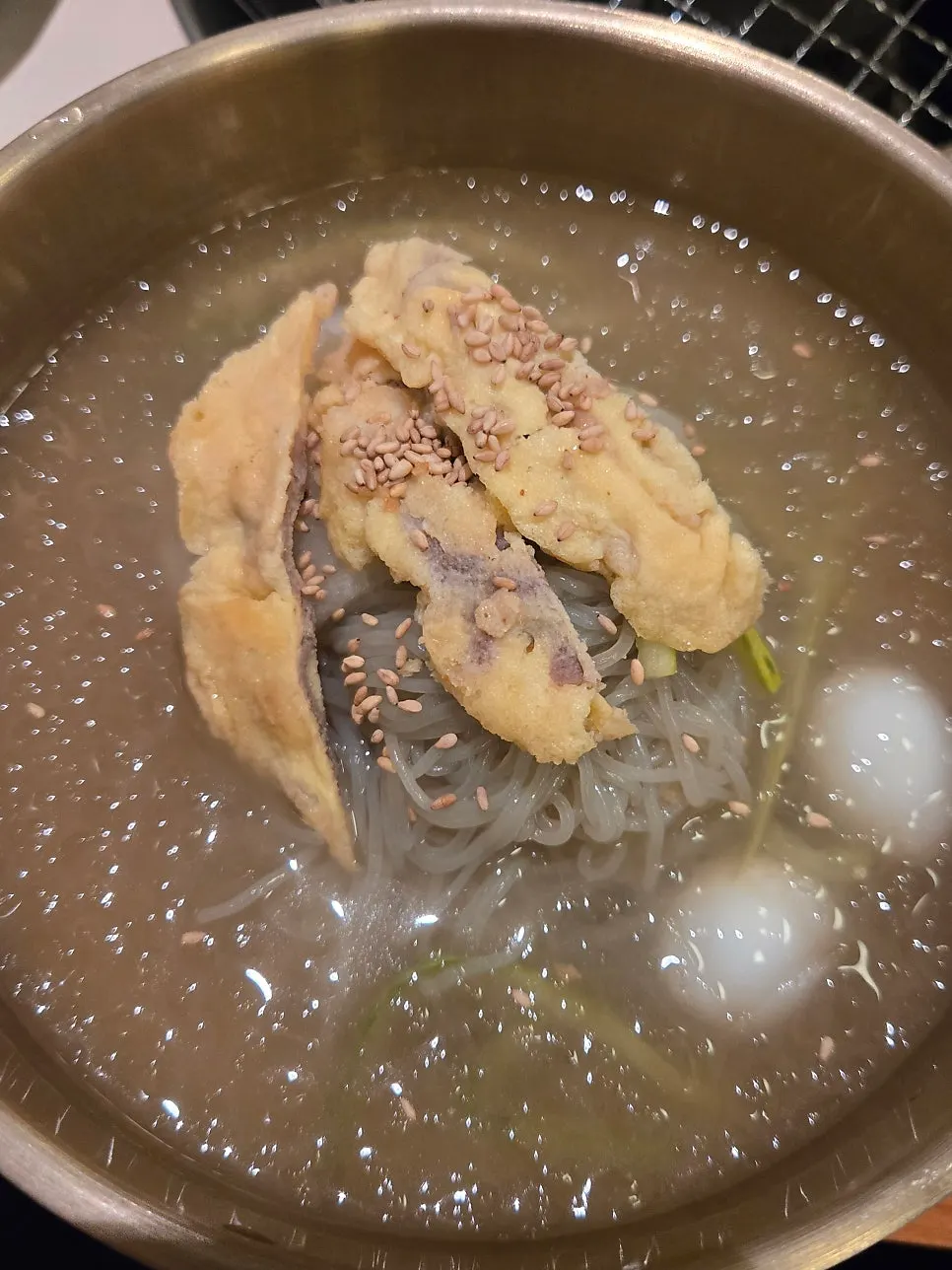 Hamheung mul-naengmyeon topped with yukjeon