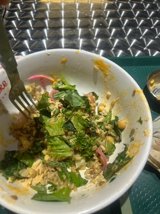 Poke toppings including corn, chickpeas, and barley rice