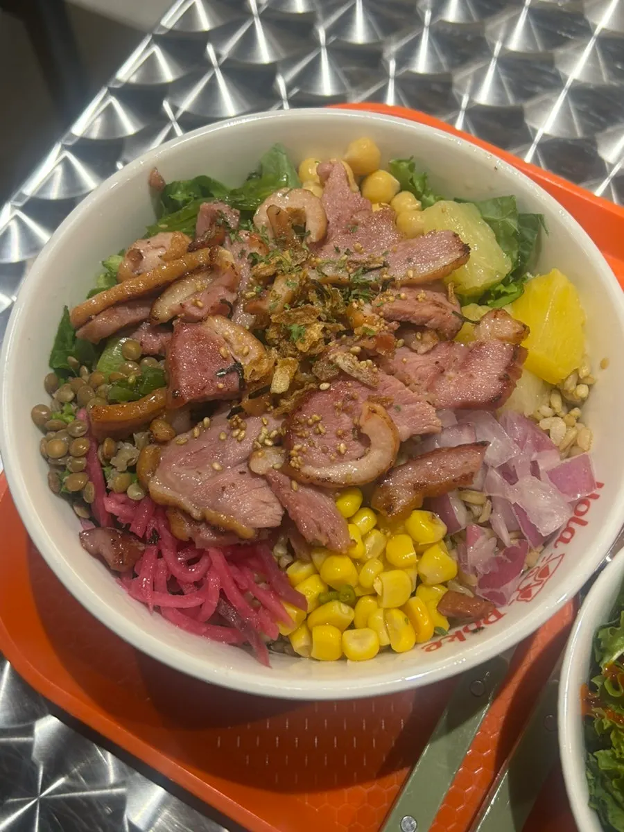 A bowl of smoked duck poke cooked fresh to order